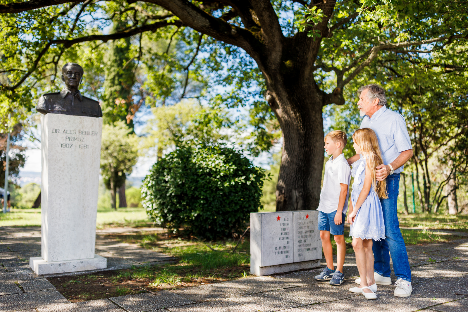 Otroka z dedkom v spominskem parku